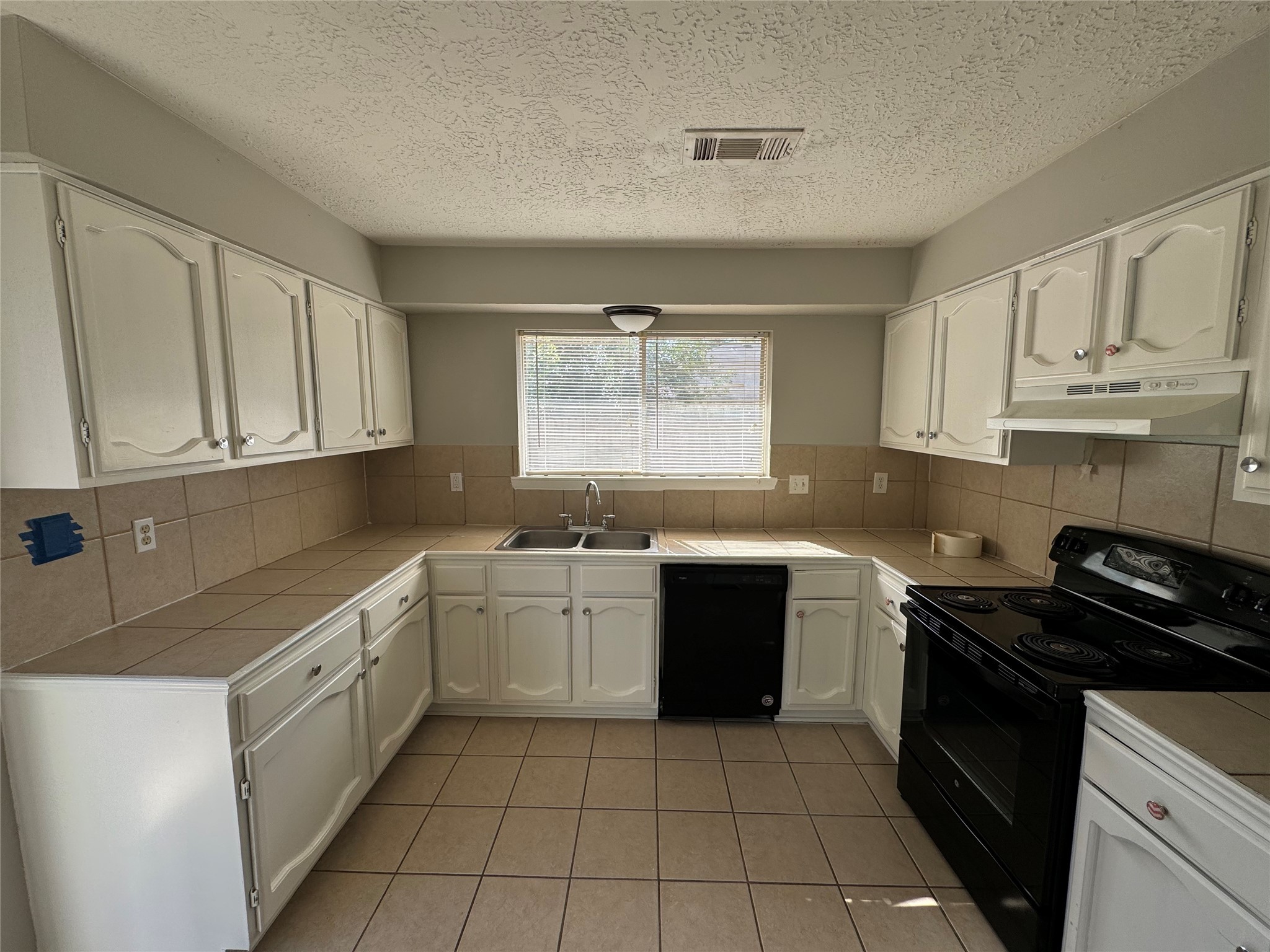 23227 Low Ridge Road Spring, TX 77373 - Photo 9 of 22 a kitchen with cabinets appliances a sink and a window