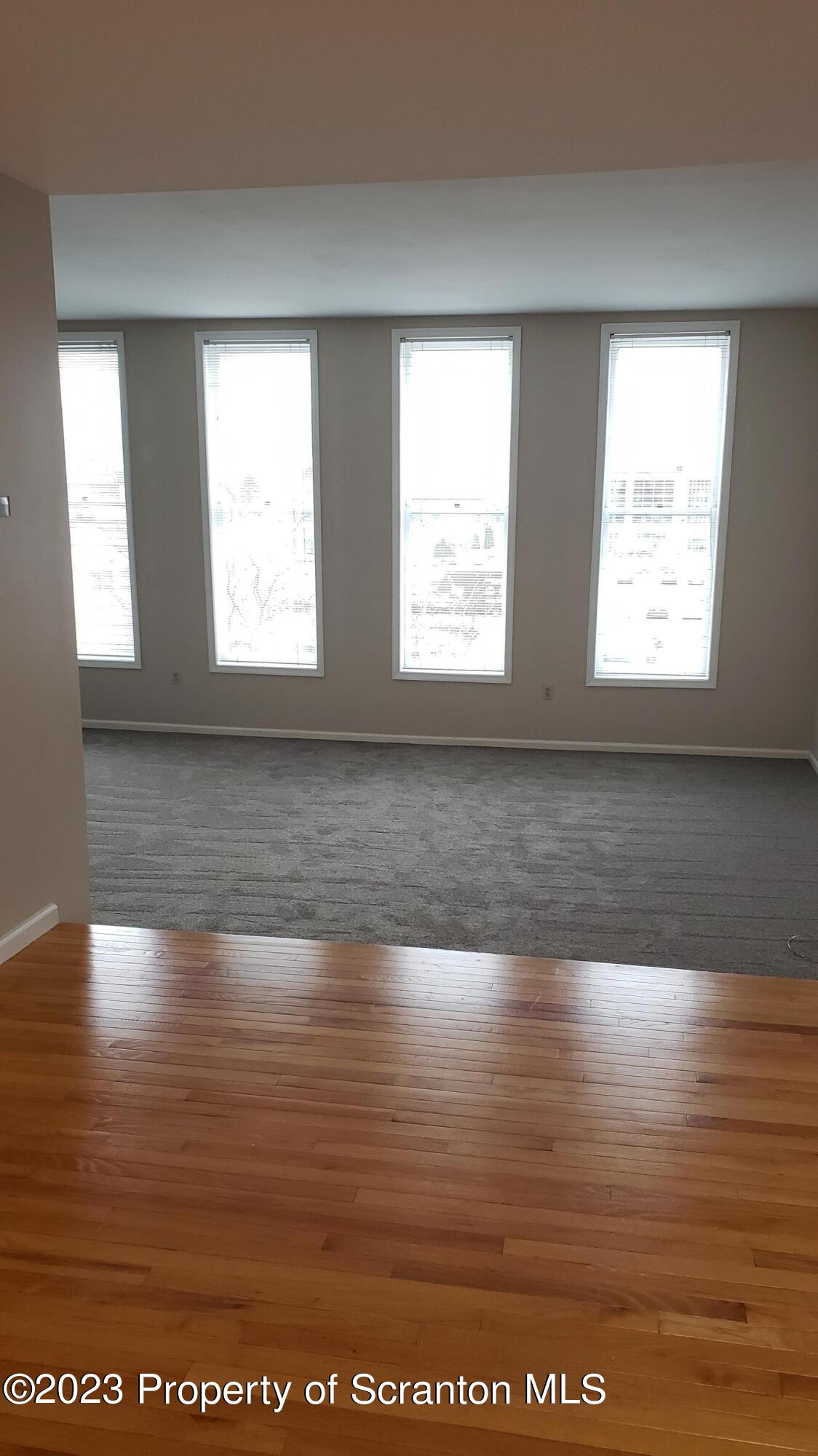 318 Penn Avenue Scranton, PA 18503 - Photo 43 of 70 a view of an empty room with wooden floor and a window