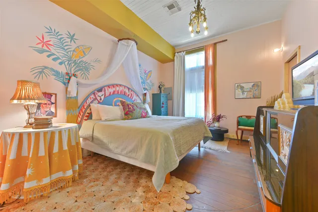 a bedroom with a bed dresser and a window