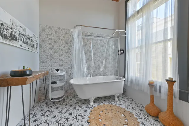 a bath room with a toilet a bath tub and a shower
