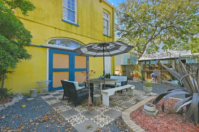 a view of a patio with table and chairs under an umbrella