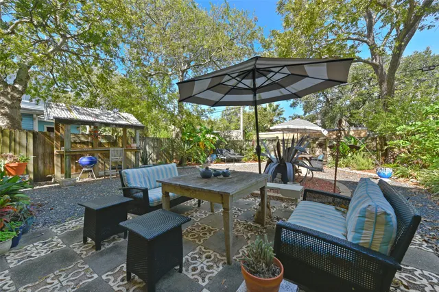 a patio with tables and chairs