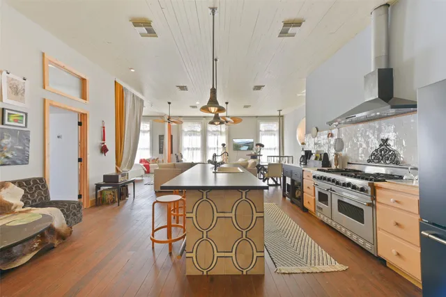 a kitchen with stainless steel appliances granite countertop a stove and cabinets