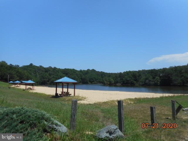 12447 Ridge Road Lusby, MD 20657 - Photo 5 of 5 a view of a lake with a mountain in the background
