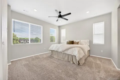 a spacious bedroom with a bed and window