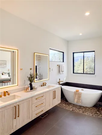 a kitchen with a sink and chairs