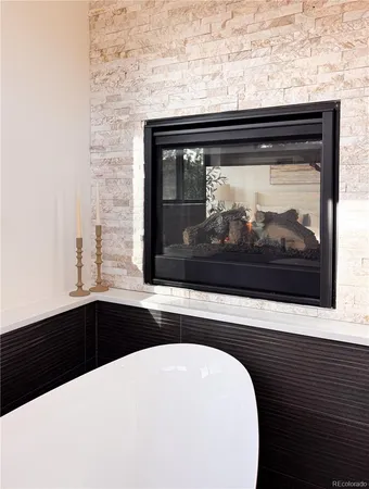 a kitchen with stainless steel appliances kitchen island granite countertop a sink and white cabinets