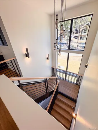 a view of a balcony with chairs and wooden floor
