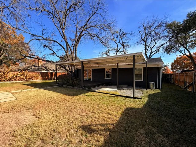a view of a house with a yard covered with snow in front of house