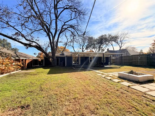a front view of house with yard covered with trees