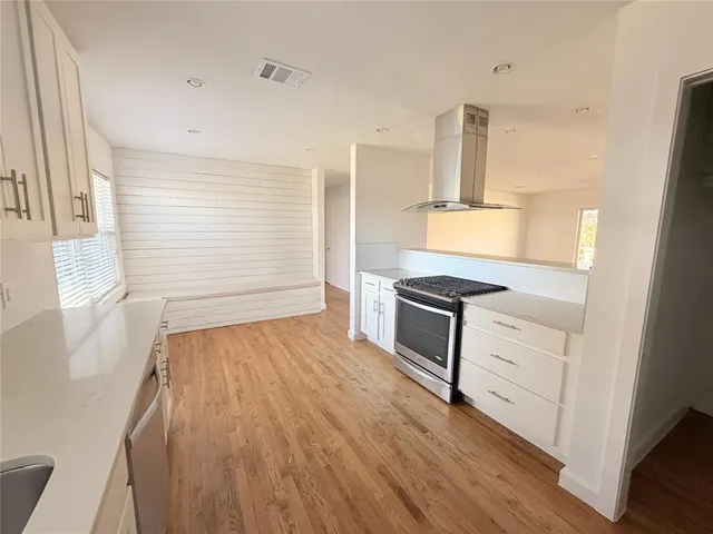 a view of kitchen with sink and wooden floor
