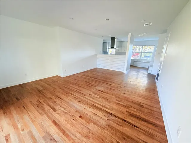 a view of a bedroom with wooden floor and cabinet