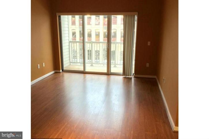 8045 Newell Street, Unit 220 Silver Spring, MD 20910 - Photo 2 of 21 Living Room w/Private Balcony