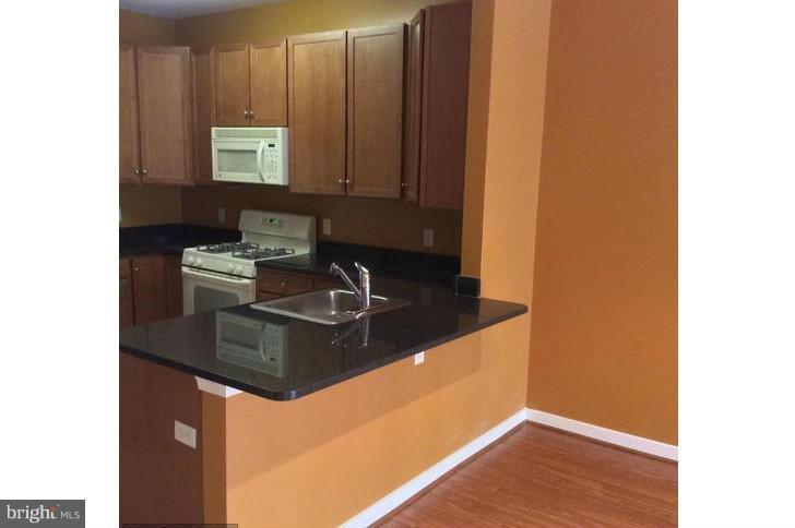 8045 Newell Street, Unit 220 Silver Spring, MD 20910 - Photo 4 of 21 Kitchen w/Breakfast Bar