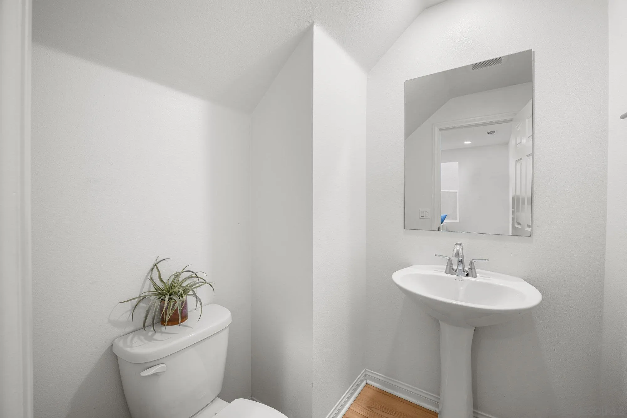 2612 Babaco Street Spring Valley, CA 91977 - Photo 14 of 37 a bathroom with a toilet sink and mirror