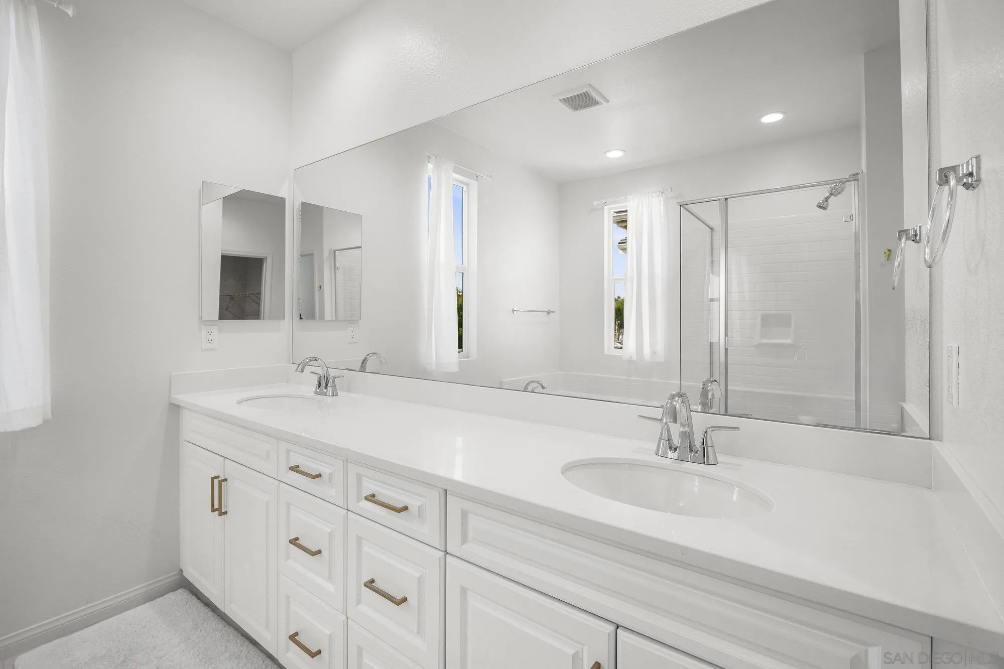 2612 Babaco Street Spring Valley, CA 91977 - Photo 19 of 37 a bathroom with double vanity sinks and a mirror