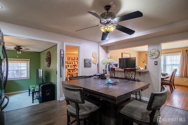 a view of a dining room with furniture and wooden floor