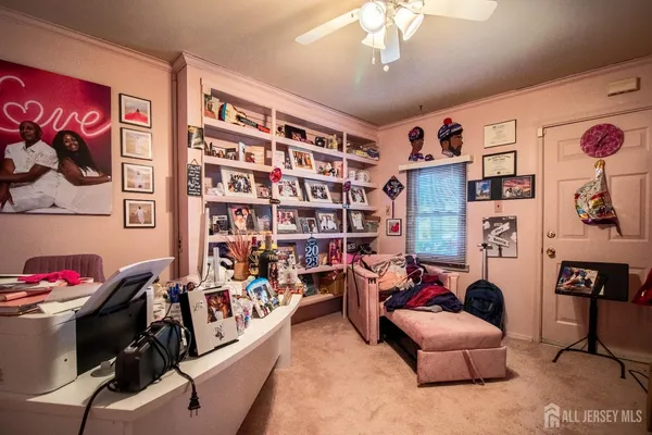 a living room with furniture and book shelf