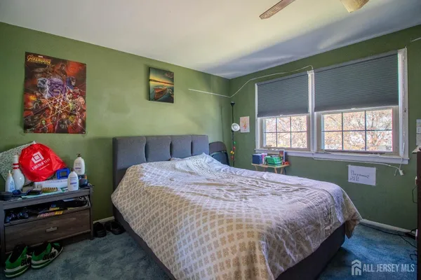 a bedroom with bed and window