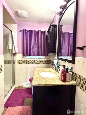 a bathroom with a sink vanity and a bathtub