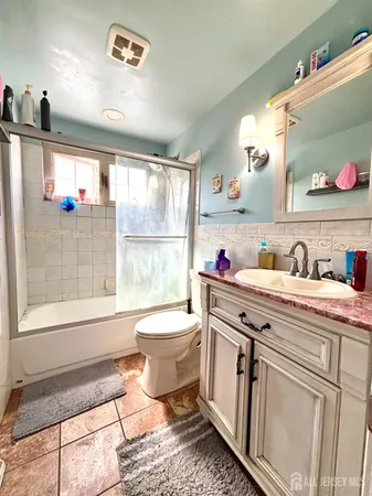 a bathroom with a toilet sink and mirror
