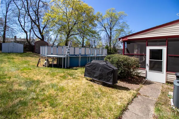 a view of a house with a yard and sitting area