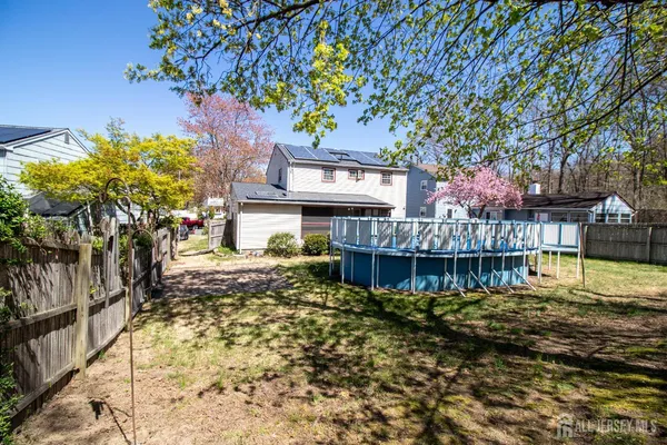 a view of a house with a large tree and a yard