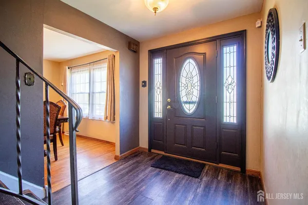a view of an entryway with wooden floor