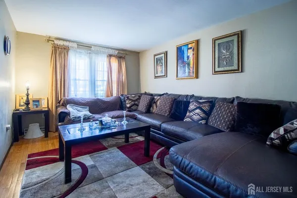 a living room with furniture potted plant and a window