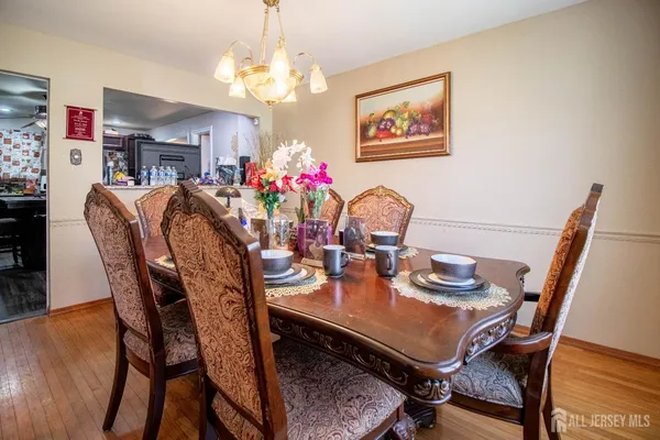 a view of a dining room with furniture and chandelier