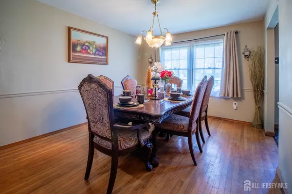 a dining room with furniture and wooden floor