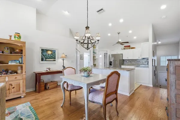 a kitchen with stainless steel appliances granite countertop a stove top oven a sink and a microwave