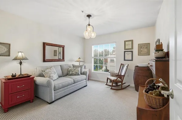 a room with stainless steel appliances lots of white furniture and empty room