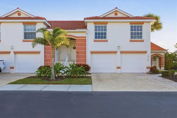 a front view of a house with a yard and a garage
