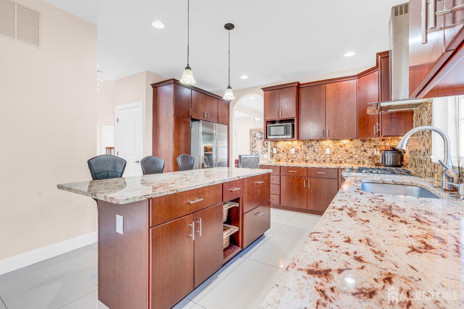 114 Holly Road Iselin, NJ 08830 - Photo 14 of 47 a kitchen with stainless steel appliances granite countertop a sink a stove and a refrigerator