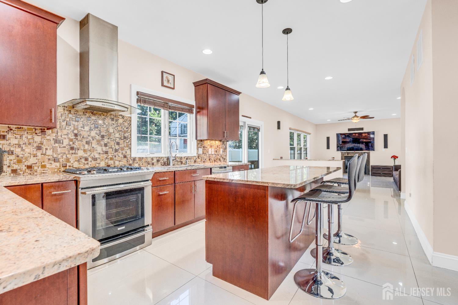 114 Holly Road Iselin, NJ 08830 - Photo 15 of 47 a kitchen with stainless steel appliances granite countertop a sink stove and refrigerator