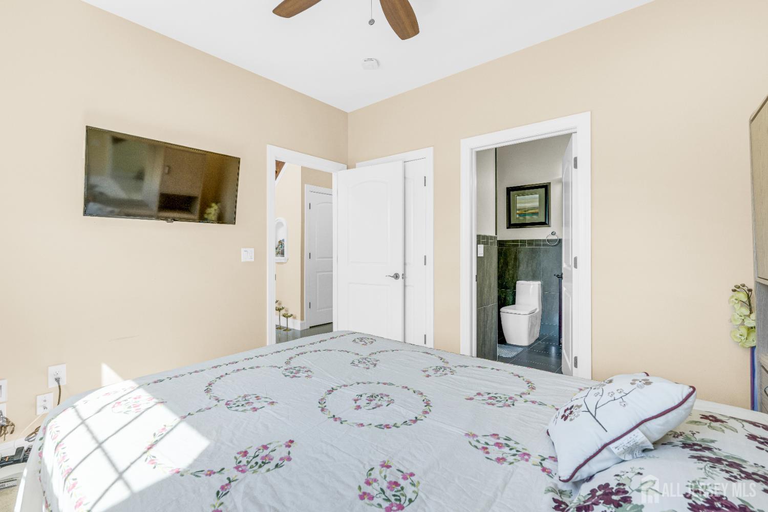 114 Holly Road Iselin, NJ 08830 - Photo 19 of 47 a bedroom with a bed and a television