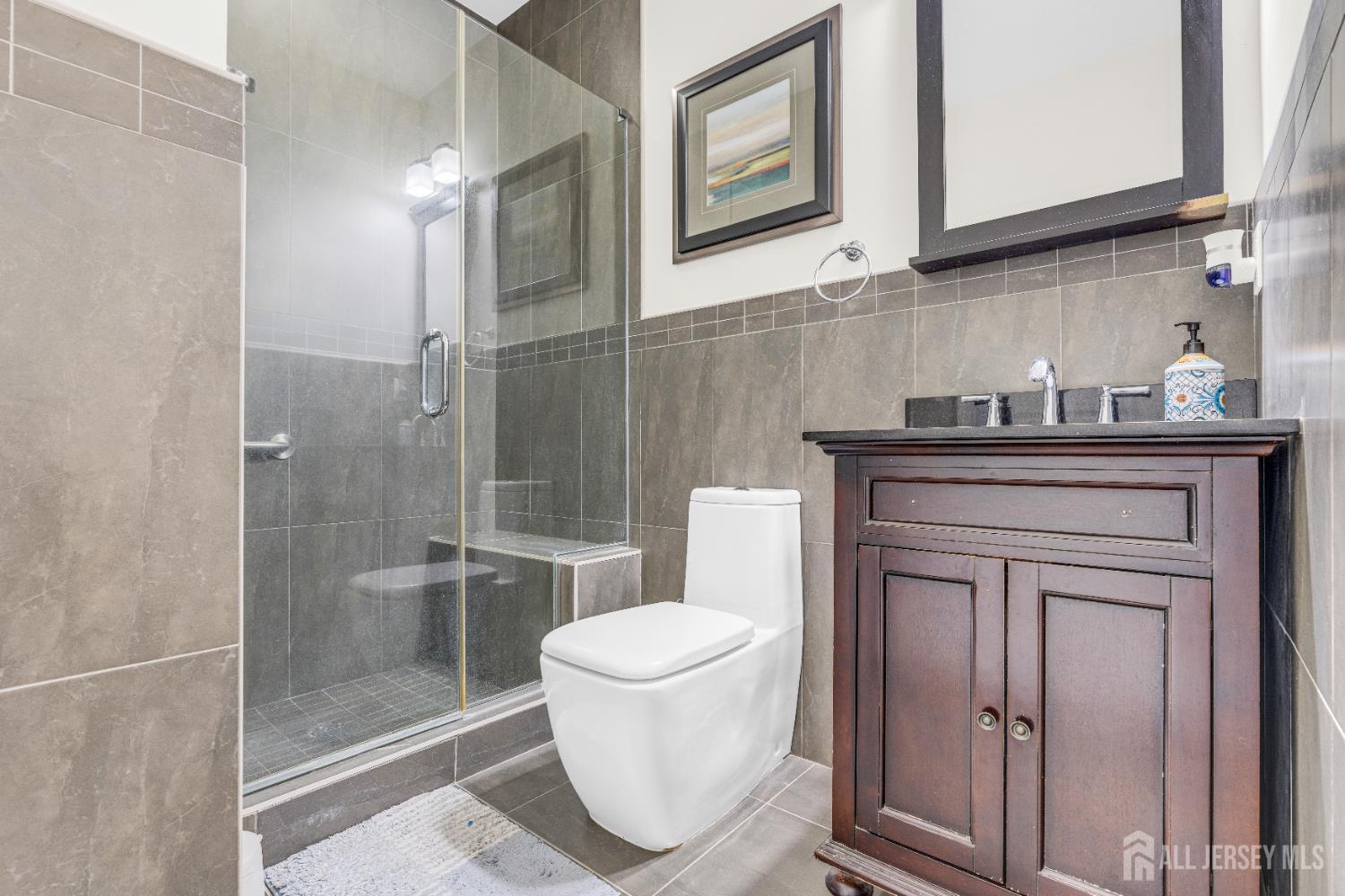 114 Holly Road Iselin, NJ 08830 - Photo 20 of 47 a bathroom with a toilet a sink and glass door