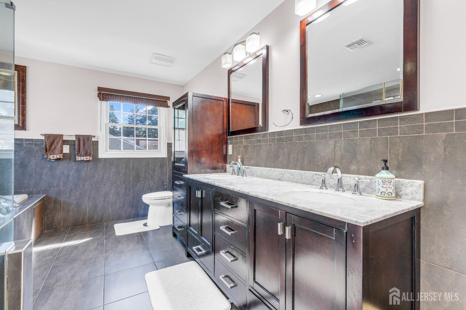 114 Holly Road Iselin, NJ 08830 - Photo 23 of 47 a bathroom with a sink and a mirror