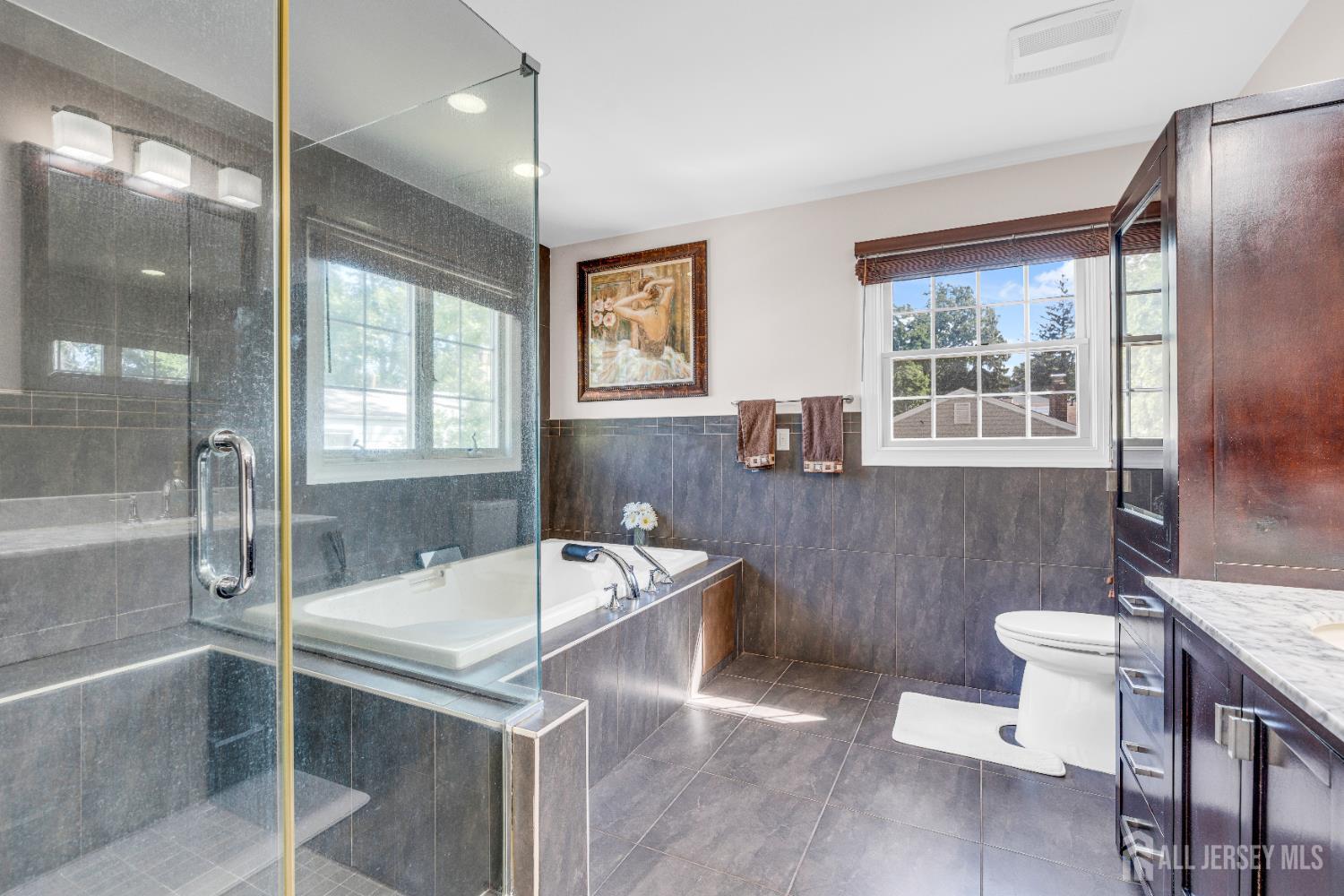 114 Holly Road Iselin, NJ 08830 - Photo 24 of 47 a bathroom with a sink a toilet a mirror and bathtub