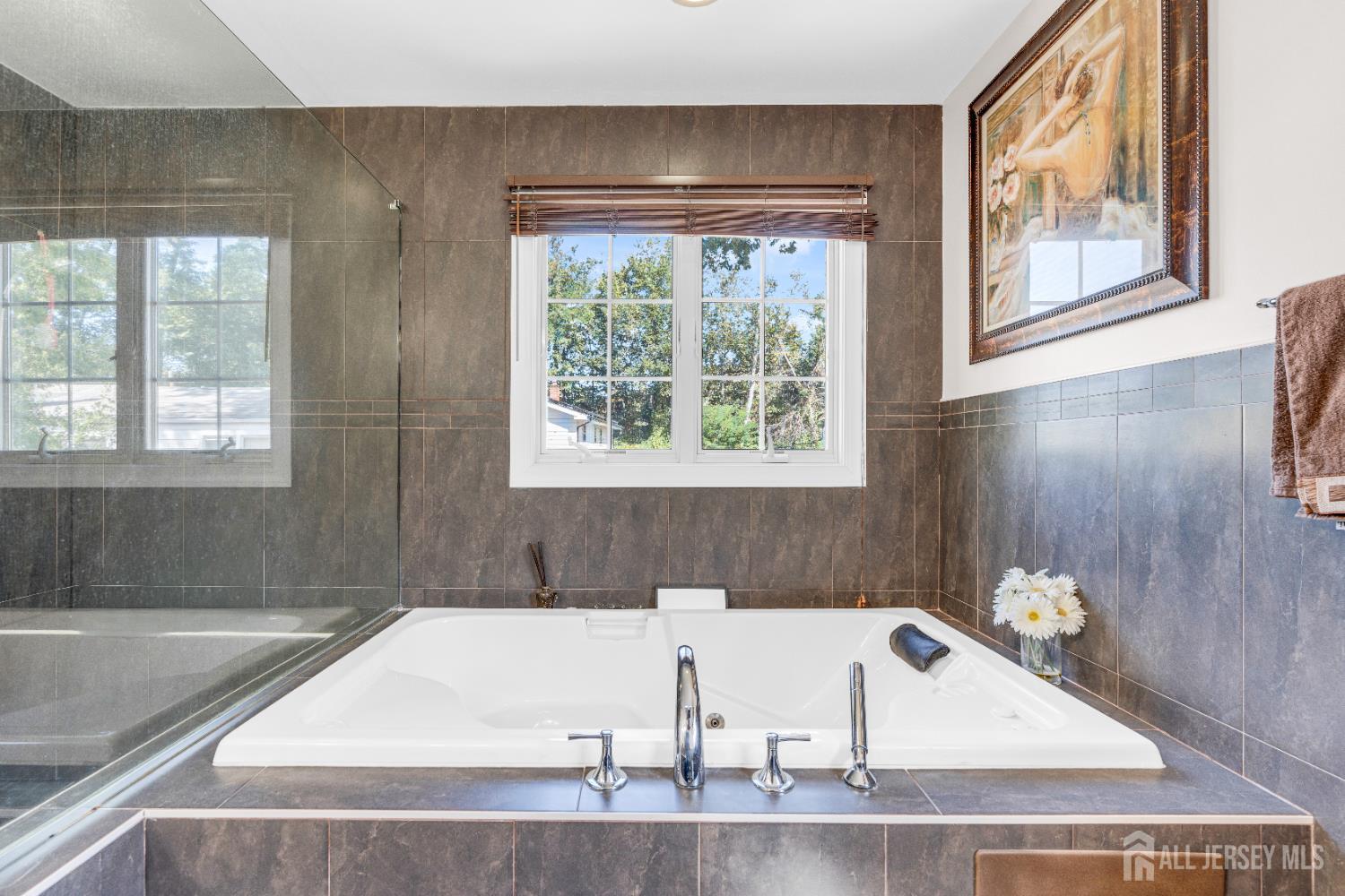 114 Holly Road Iselin, NJ 08830 - Photo 25 of 47 a bath tub sitting in a bathroom next to a window