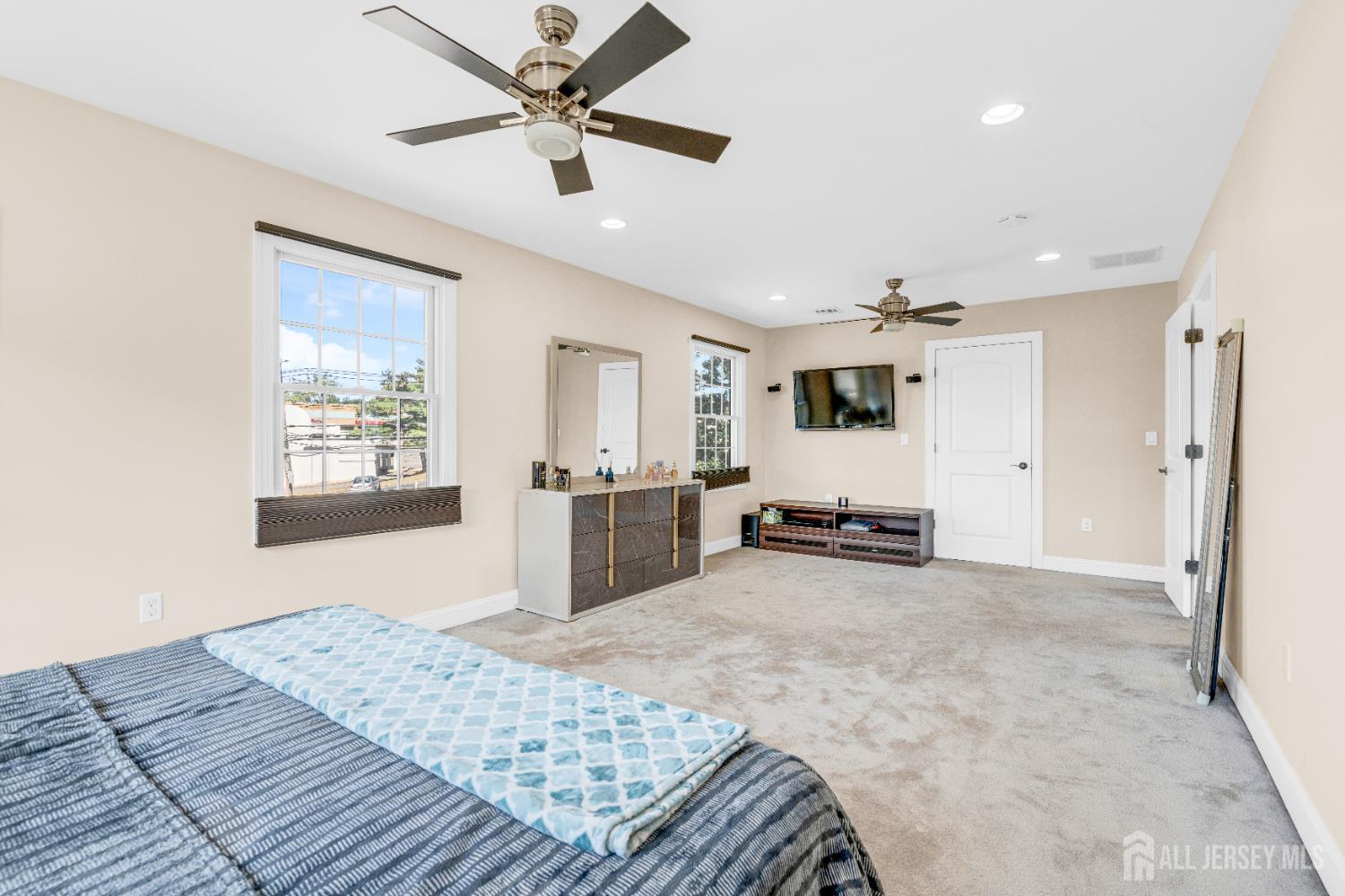 114 Holly Road Iselin, NJ 08830 - Photo 29 of 47 a bedroom with a bed and ceiling fan