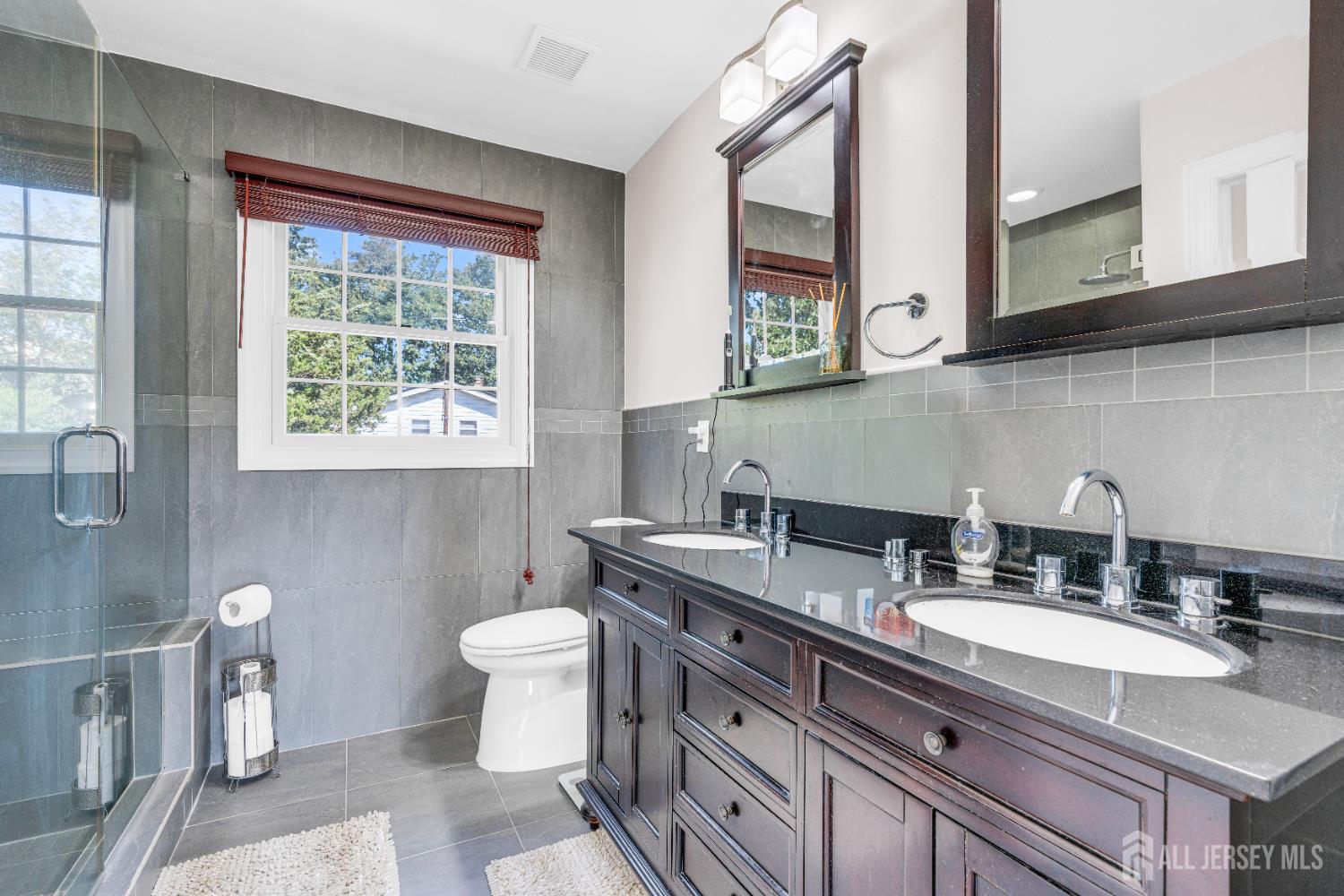 114 Holly Road Iselin, NJ 08830 - Photo 30 of 47 a bathroom with a granite countertop toilet sink and mirror