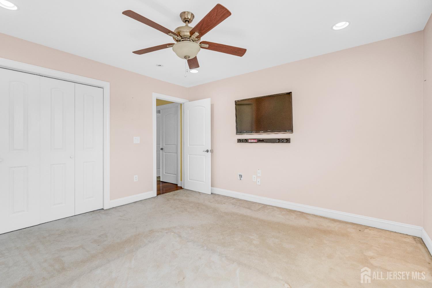 114 Holly Road Iselin, NJ 08830 - Photo 32 of 47 en empty room with ceiling fan and window