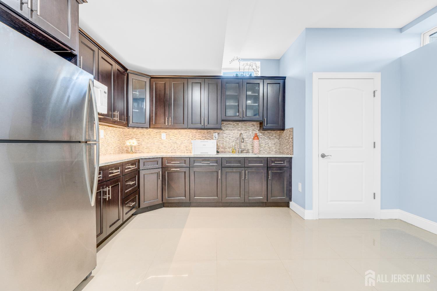 114 Holly Road Iselin, NJ 08830 - Photo 39 of 47 a kitchen with stainless steel appliances a refrigerator and a stove