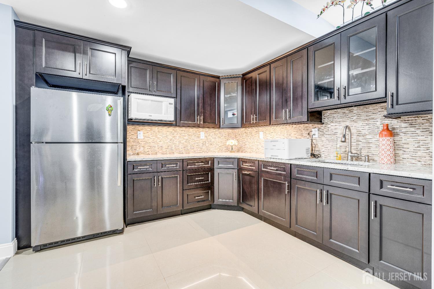 114 Holly Road Iselin, NJ 08830 - Photo 40 of 47 a kitchen with stainless steel appliances granite countertop a refrigerator stove top oven and sink