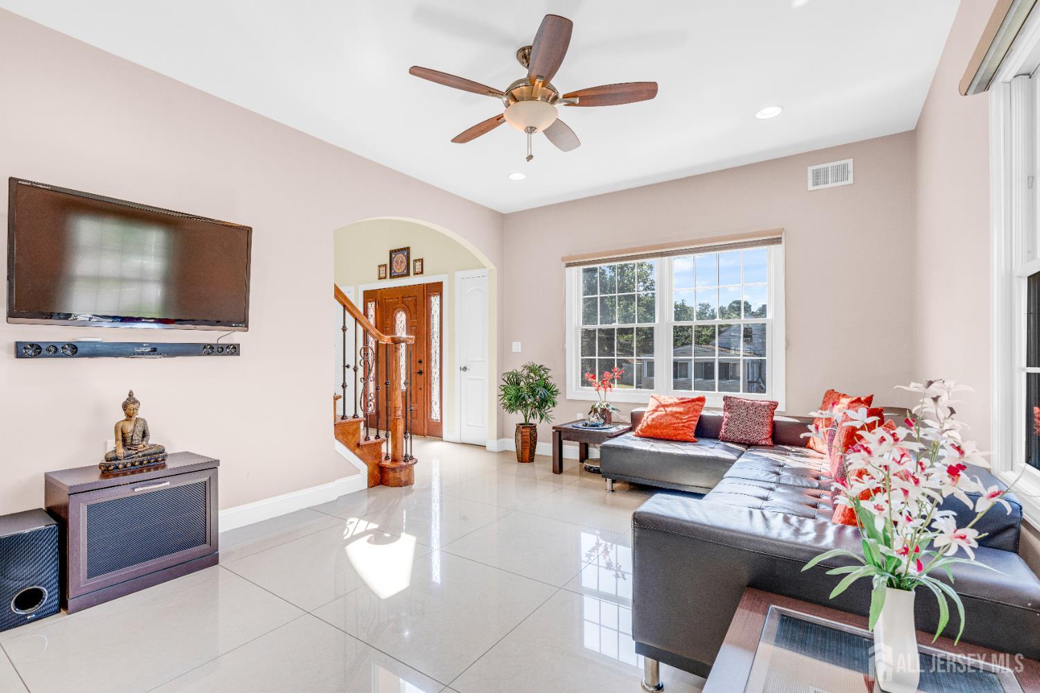 114 Holly Road Iselin, NJ 08830 - Photo 9 of 47 a living room with furniture and a flat screen tv