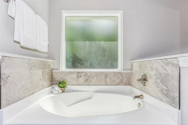 a spacious bathroom with a double vanity sink and mirror
