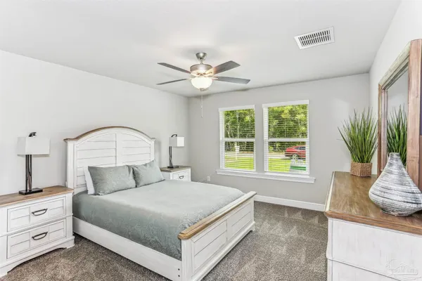 a bedroom with a bed and a dresser