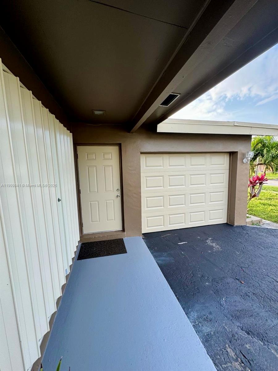 8670 Northwest 28th Place Sunrise, FL 33322 - Photo 3 of 13 a view of empty room with garage and window